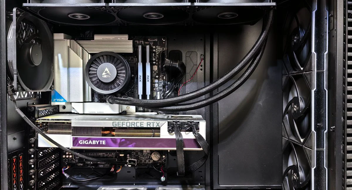 Interior view of a gaming PC showcasing a GeForce RTX graphics card and high-performance cooling system.