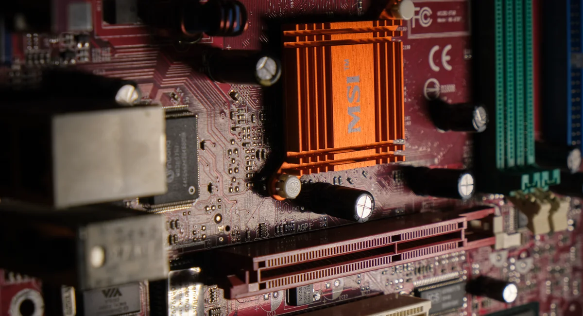 Detailed view of a computer motherboard showcasing intricate electronic components.