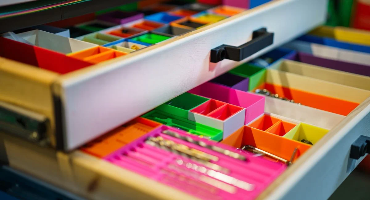A neatly arranged drawer featuring vibrant colored compartments for efficient organization.