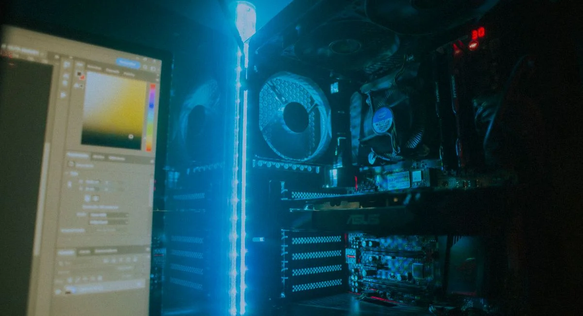 Close-up of an illuminated gaming PC setup showcasing cooling fans and hardware details.