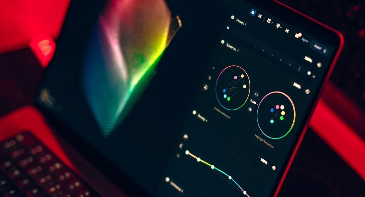 A close-up shot of a laptop displaying a color grading dashboard with vibrant colors.