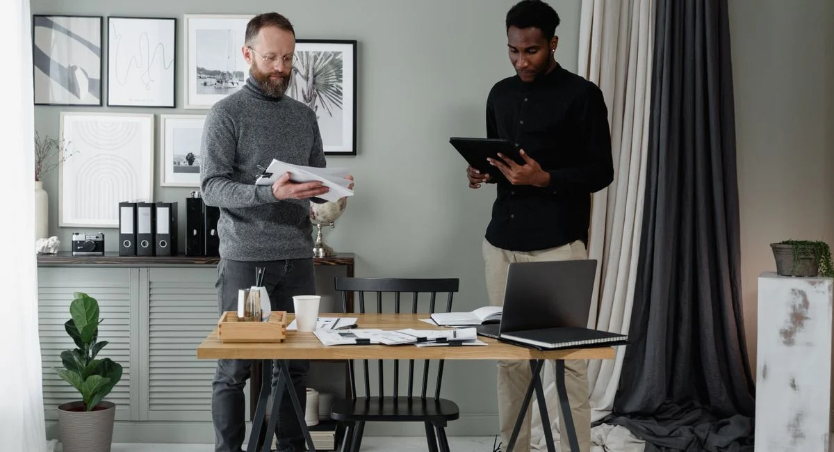 Two professionals discussing documents in a modern and stylish office environment.
